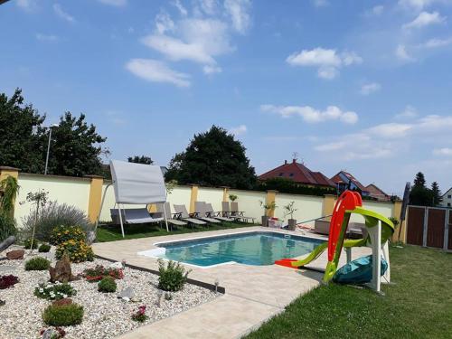 a pool with a water slide in a yard at Apartmány na kolonádě in Lednice