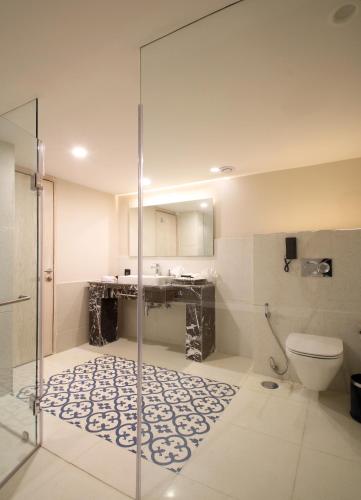 a bathroom with a shower and a toilet at Sarovar Premiere Jaipur in Jaipur