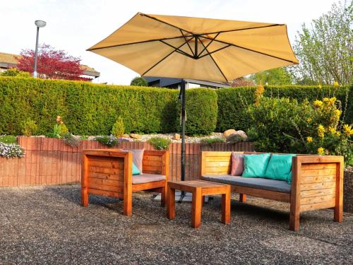 a patio with two chairs and an umbrella at Holiday Home in Mielinghausen with Garden Terrace in Reiste