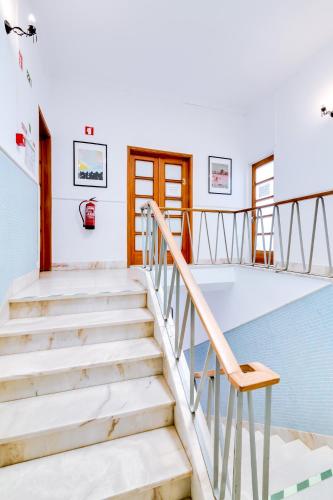 a staircase in a house with a chair at À da Avó -The Guesthouse in Faro