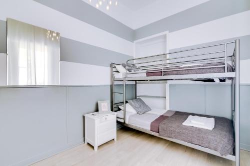 a bedroom with two bunk beds and a mirror at À da Avó -The Guesthouse in Faro