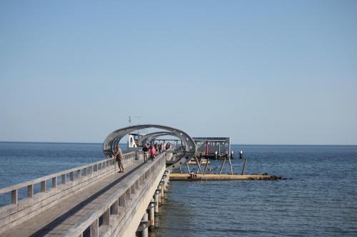 a group of people walking on a pier over the water at Sonnengarten 17 in Kellenhusen