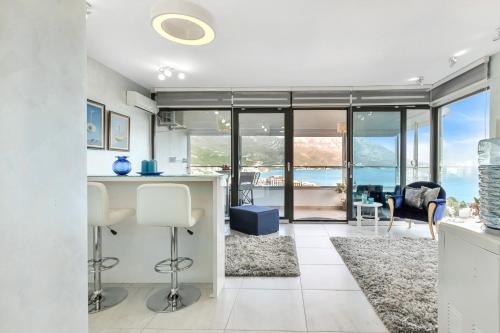 a kitchen and living room with a view of the ocean at Apartment 4You in Budva
