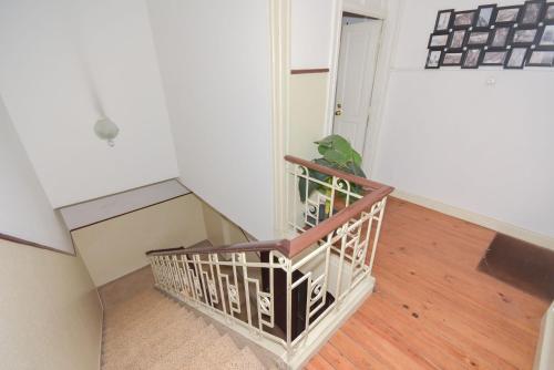an empty room with a staircase with a plant at Oporto Rivoli Apartments in Porto