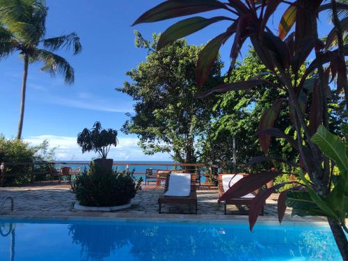 a resort pool with a view of the ocean at Hotel Casablanca in Pipa