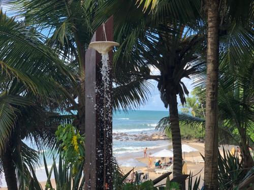a water fountain on a beach with palm trees at Hotel Casablanca in Pipa