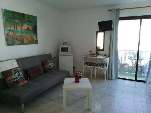 a living room with a couch and a table at Casa Luisa in Caleta De Fuste