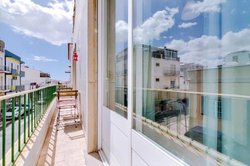 a balcony with a view of a building at À da Avó -The Guesthouse in Faro