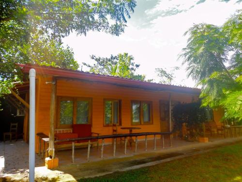 a small yellow house with a picnic table in front of it at Popa Paradise Beach Resort in Buena Vista