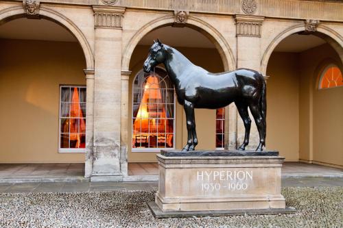 a statue of a horse in front of a building at The Jockey Club Rooms in Newmarket