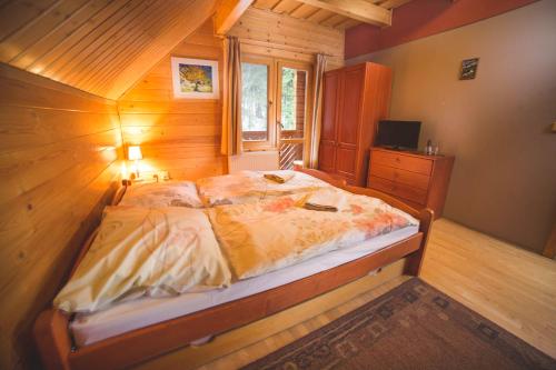 A bed or beds in a room at Penzión Racibor