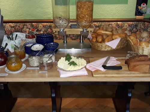 a table with bread and other food items on it at Schwarzes Ross in Arnsdorf