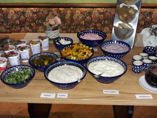 a table with bowls of food on a table at Schwarzes Ross in Arnsdorf