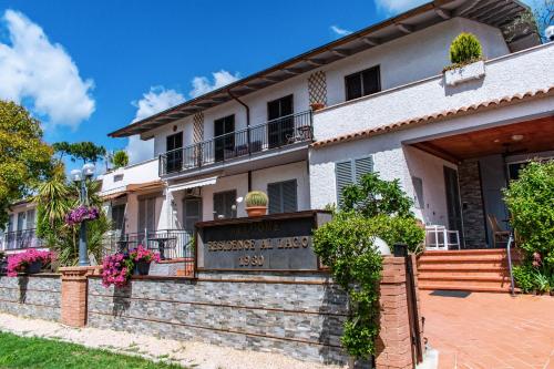 a house with a sign in front of it at Residence Al Lago in Castiglione del Lago