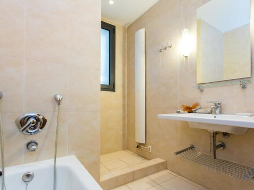 a bathroom with a shower and a sink and a tub at TarracoHomes, Villa with Botanic Garden and Private Pool facing the Beach in Miami Platja