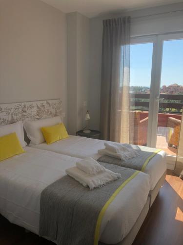 Postel nebo postele na pokoji v ubytování Ático de Lujo Playa Granada, BLUE&GREEN