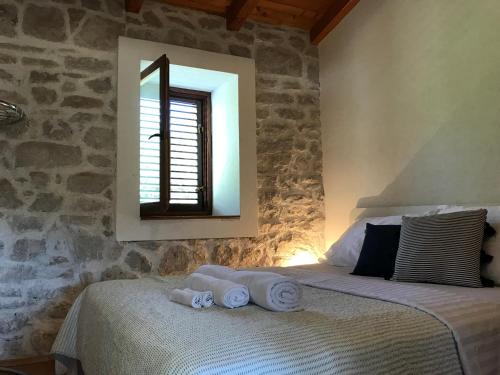 a bedroom with a bed with towels on it at Villa Mediterranea in Murter