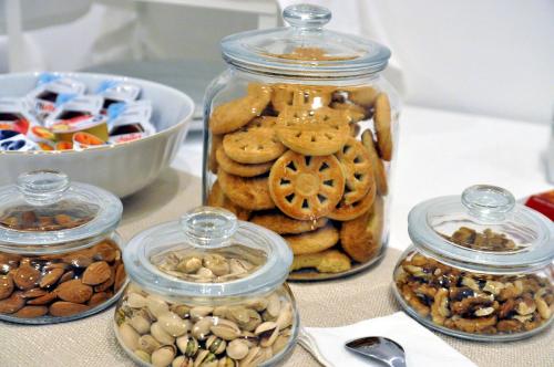 a table topped with jars of cookies and nuts at Palazzo Lauritano in Agerola