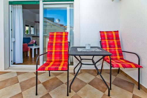 two chairs and a table in a room at Apartments Bubalo in Hvar