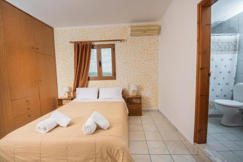 ein Schlafzimmer mit einem Bett mit zwei Handtüchern darauf in der Unterkunft Irene Komos in Pitsidia