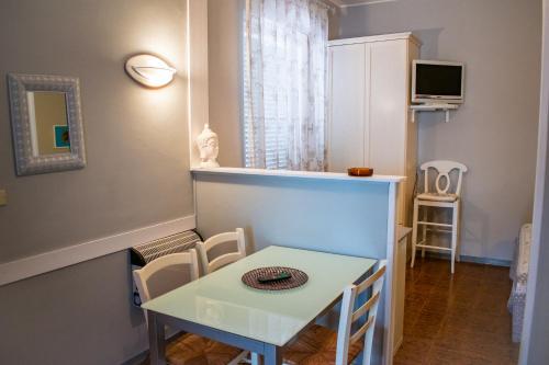 a small dining room with a white table and chairs at Residence Al Lago in Castiglione del Lago