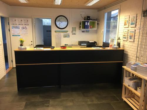 a counter in a room with a clock on the wall at Hirtshals Camping in Hirtshals