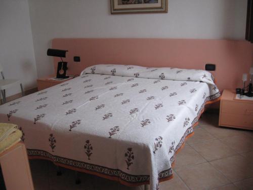 a bedroom with a bed with a white blanket at Casa Porto Corallo in Villaputzu