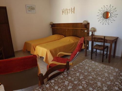 - une chambre avec 2 lits, un bureau et une table dans l'établissement Studio n°5 agréable et bien situé, à Amélie-les-Bains-Palalda
