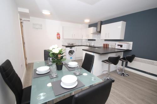 a kitchen and dining room with a table and chairs at Fox Street Delight in Liverpool