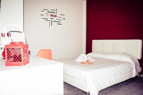 a bedroom with a white bed and a table at B&B Alto Salento - Pool and Sun in Pulsano