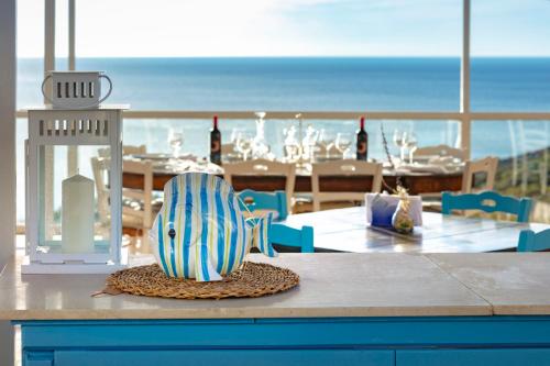 a dining room with a table with a view of the ocean at Hotel Pocho in San Vito lo Capo