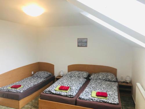 two beds in a small room with two at Penzion Hůrka in Pardubice