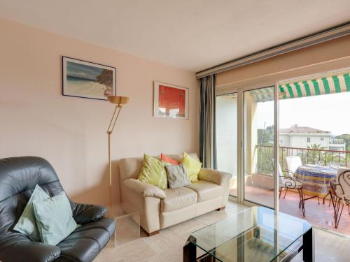 a living room with a couch and a glass table at Apartment Boulouris Mimosa by Interhome in Saint-Raphaël