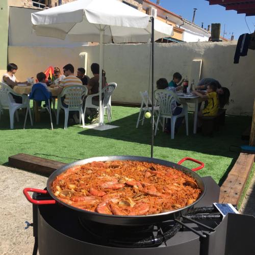 una gran sartén de comida en la parte superior de una parrilla en La Manguita Bardenas, en Arguedas