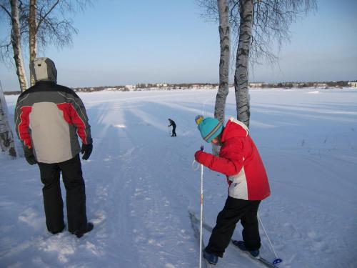 two people on skis standing in the snow at E-City B&B in Tornio
