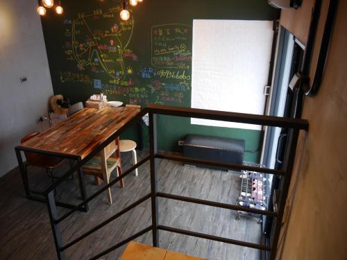 a room with a table and a chalkboard on the wall at Groupei in Nanwan