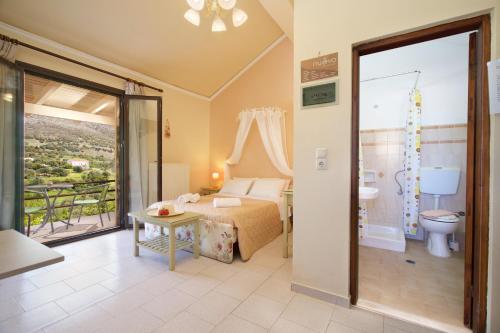 a bedroom with a bed and a bathroom at Minas Apartments in Divarata