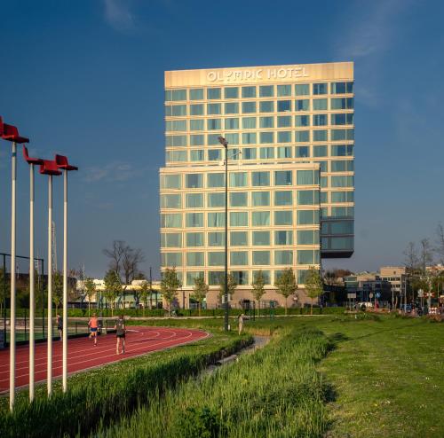 a hotel building with people running on a race track at Olympic Hotel in Amsterdam