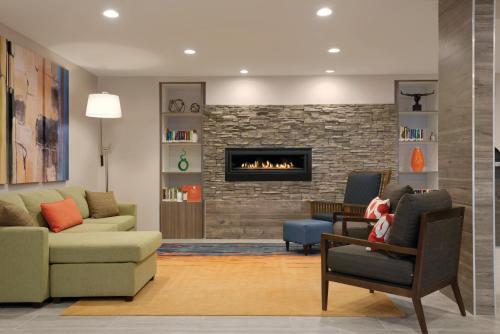 a living room with a couch and a fireplace at Country Inn & Suites by Radisson, Shoreview-Mounds View, MN in Mounds View