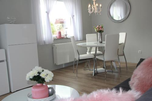 a living room with a table and white chairs at Apartment Snježana in Slunj
