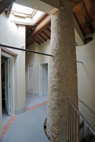a large stone column in a building with a ceiling at B&B CASAGRANDE in Quercegrossa