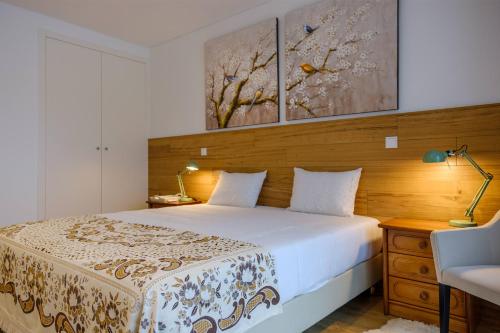 מיטה או מיטות בחדר ב-Rito Hall da Serra
