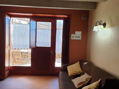 a living room with a couch and a sliding glass door at El Serrat Turisme Rural in Planoles