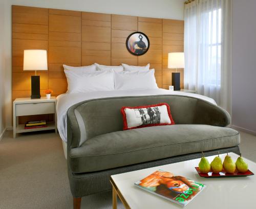 a hotel room with a bed and a couch at 21c Museum Hotel Cincinnati in Cincinnati