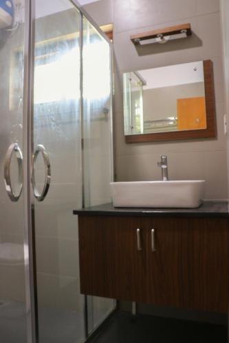 a bathroom with a sink and a mirror at Water's Edge Villas in Alleppey