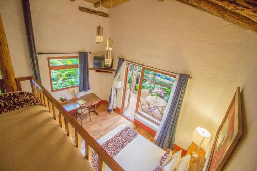 a room with a bed and a table and a window at Mesón De Leyendas Breakfast & Downtown in Valle de Bravo