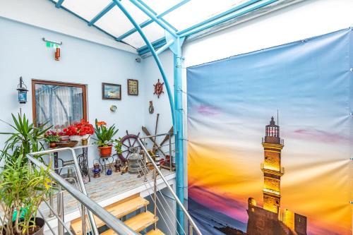 a balcony with a mural of a lighthouse at Casa Atanasiu lângă Biserica Neagră în Centrul Istoric in Braşov