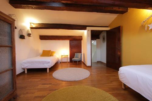 サナリー・シュル・メールにあるStellaHome - L'Enclosのベッド2台、ソファ、テーブルが備わる客室です。