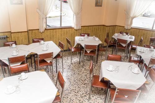a dining room table with chairs and tables at HOTEL LORENZO in Carballino