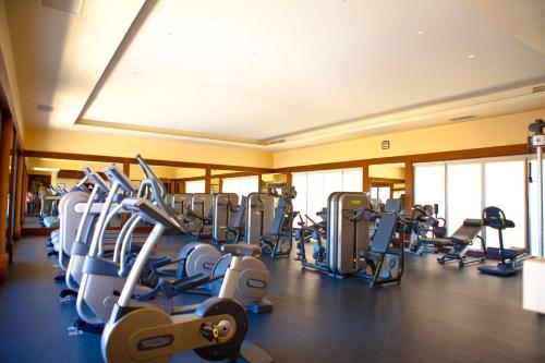 a gym with lots of cardio equipment in a room at Pueblo Bonito Montecristo Luxury Villas - All Inclusive in Cabo San Lucas